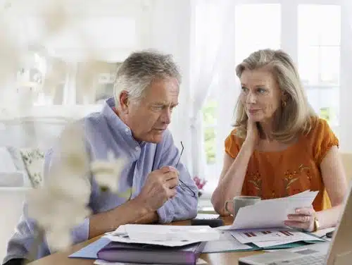 Retired couple looking at billing and they don't look happy