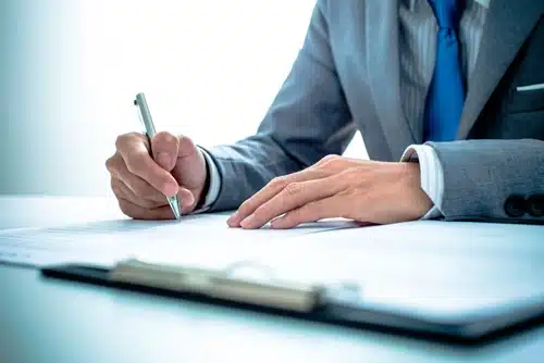 person writing with a pen