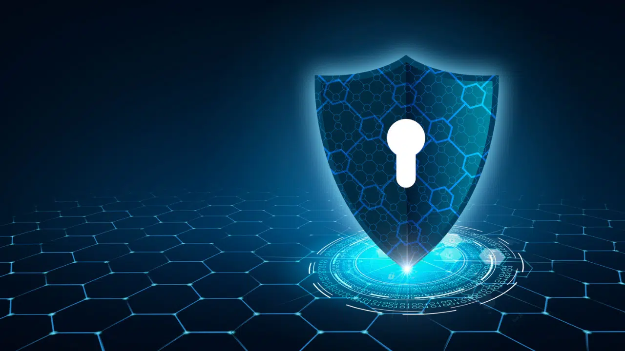 securityasagrowthstrat Blue shield with a white keyhole hovering over a glowing digital circle on a hexagonal grid, symbolizing cybersecurity.